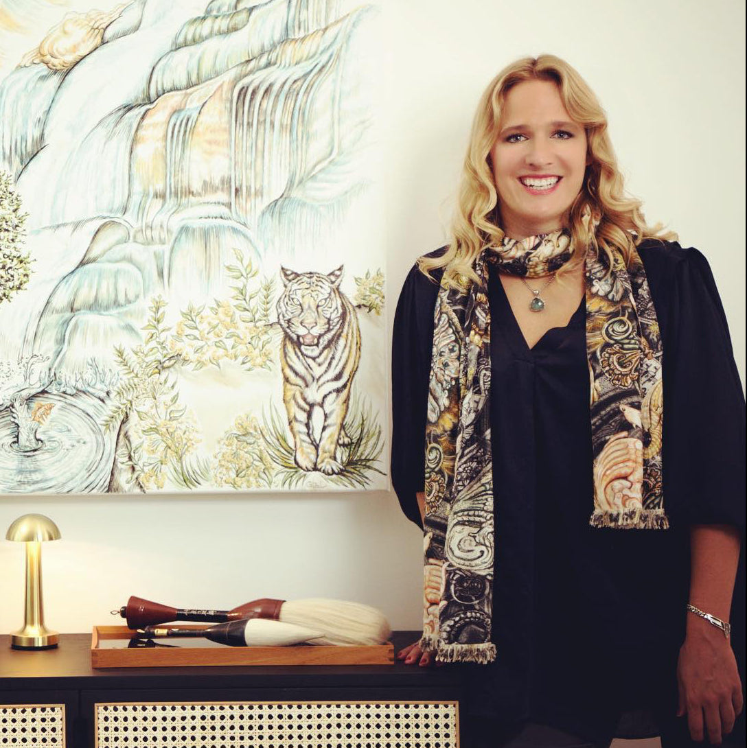 Ginny Litscher in front of her paintings