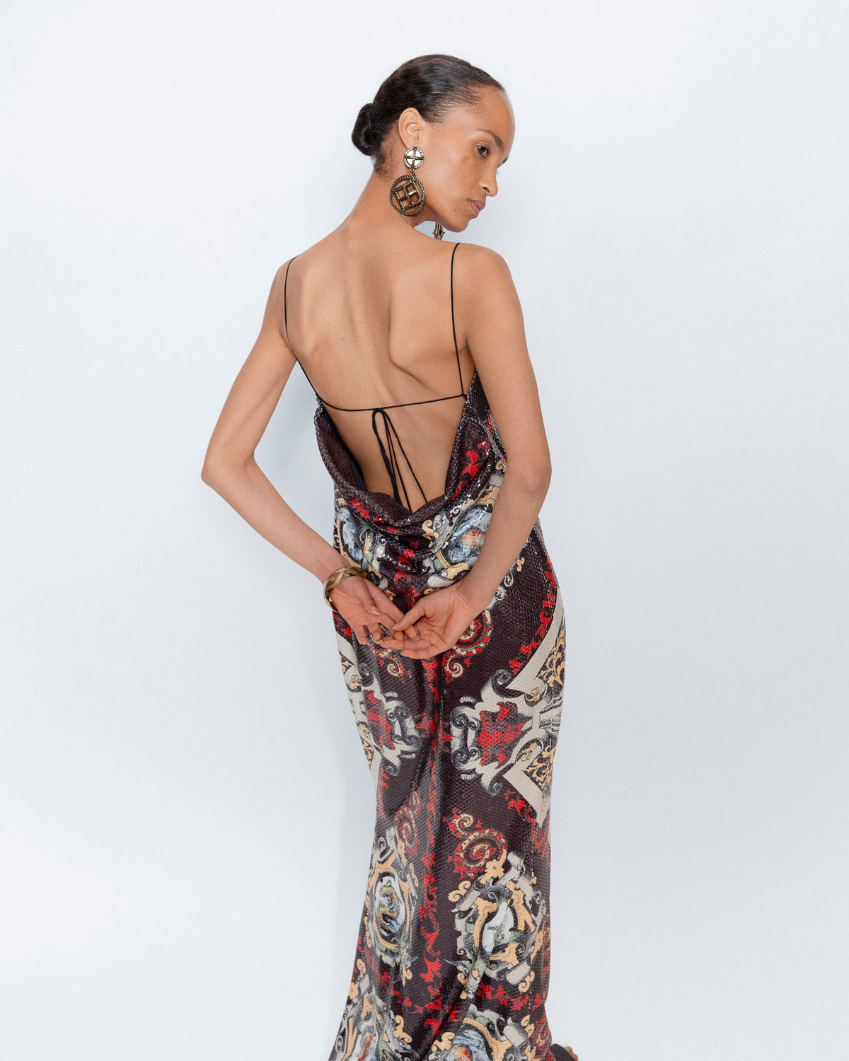 The Midnight Baroque Gown worn by a model, back view showing the open back
