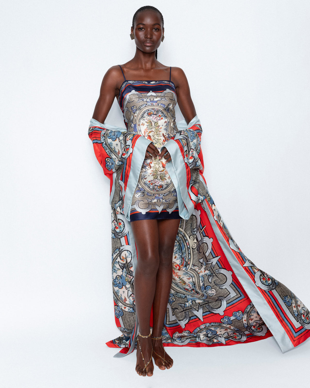 The Aviary Silk Dress worn with a long printed silk cape, full length