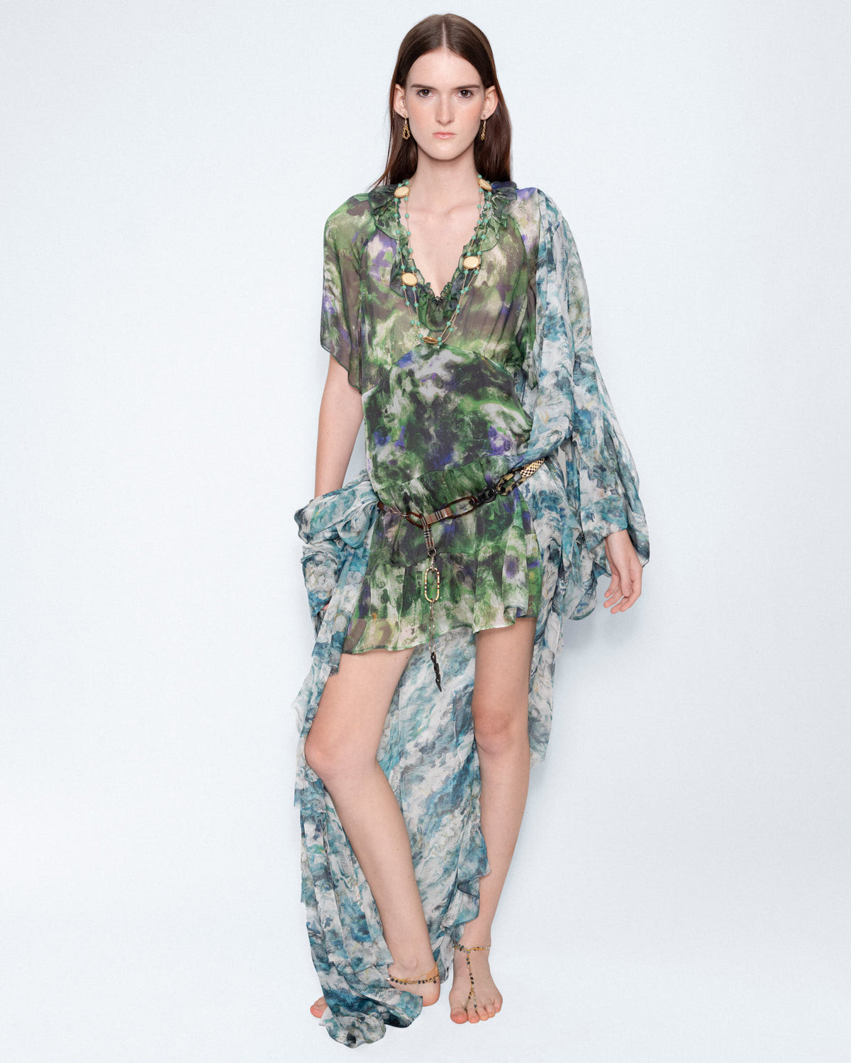 The Watercolour Ruffle-Trimmed Dress worn with a long sheer wrap, full length