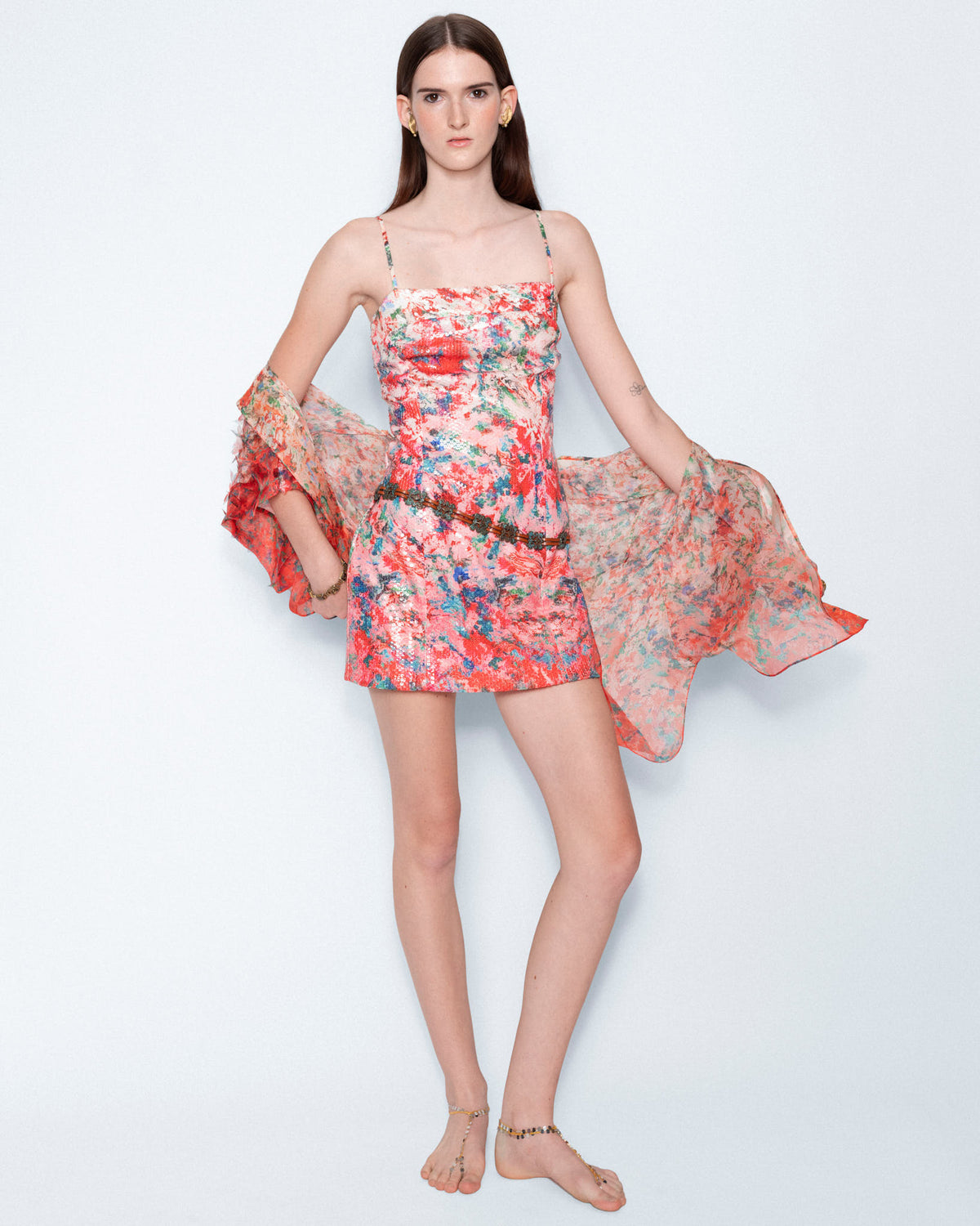 The Coral Reverie Mini Sequin Dress worn with a sheer floral wrap, full length