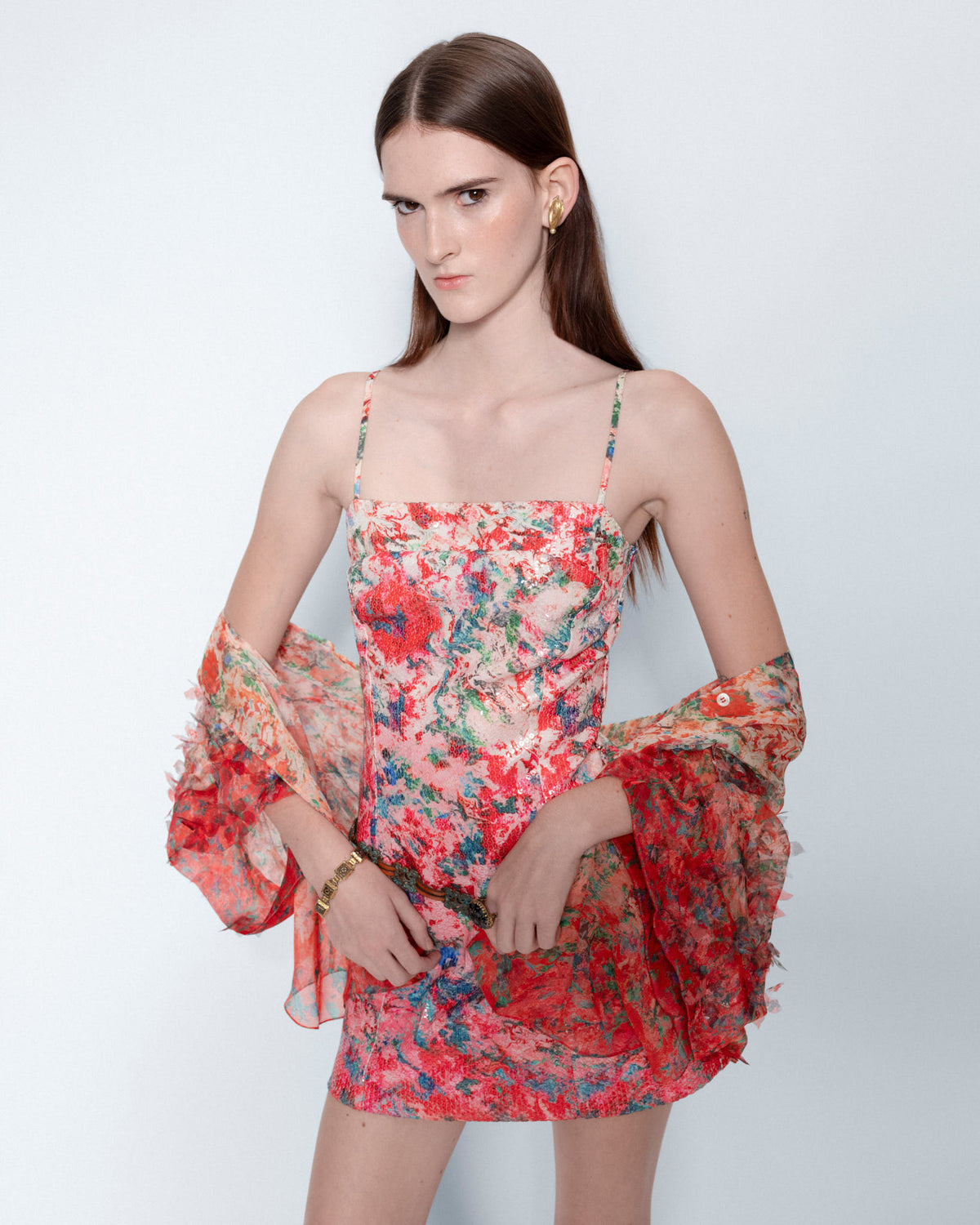 The Coral Reverie Mini Sequin Dress worn with a sheer floral wrap, close up
