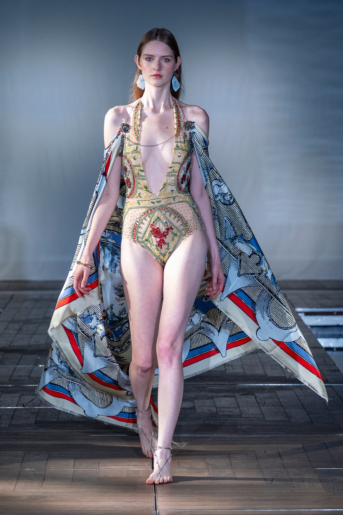 Ornate Rhinestone Halter Bodysuit worn on the runway with a printed silk cape