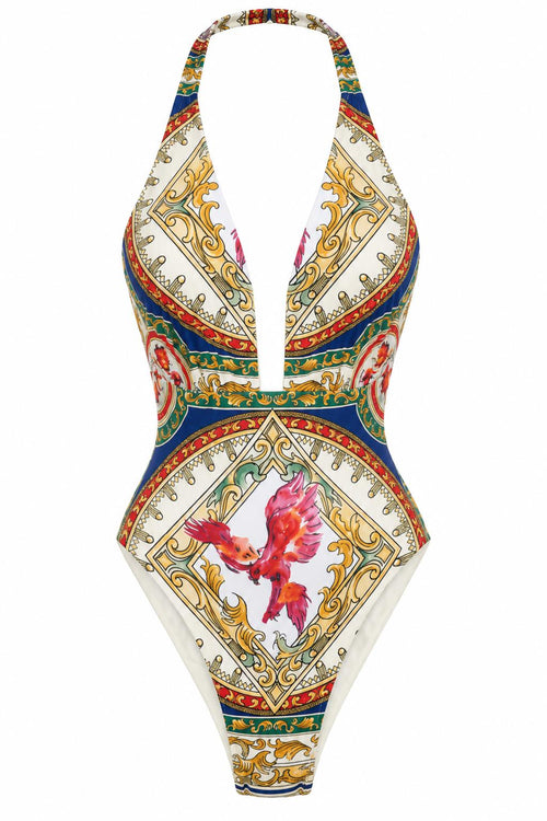 The Phoenix Bathingsuit, front: plunging halter swimsuit in a gold, blue and red baroque print with a phoenix