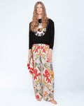 The Phoenix Stretch Jeans worn with a black knit jumper and a silk scarf at the hip, full length