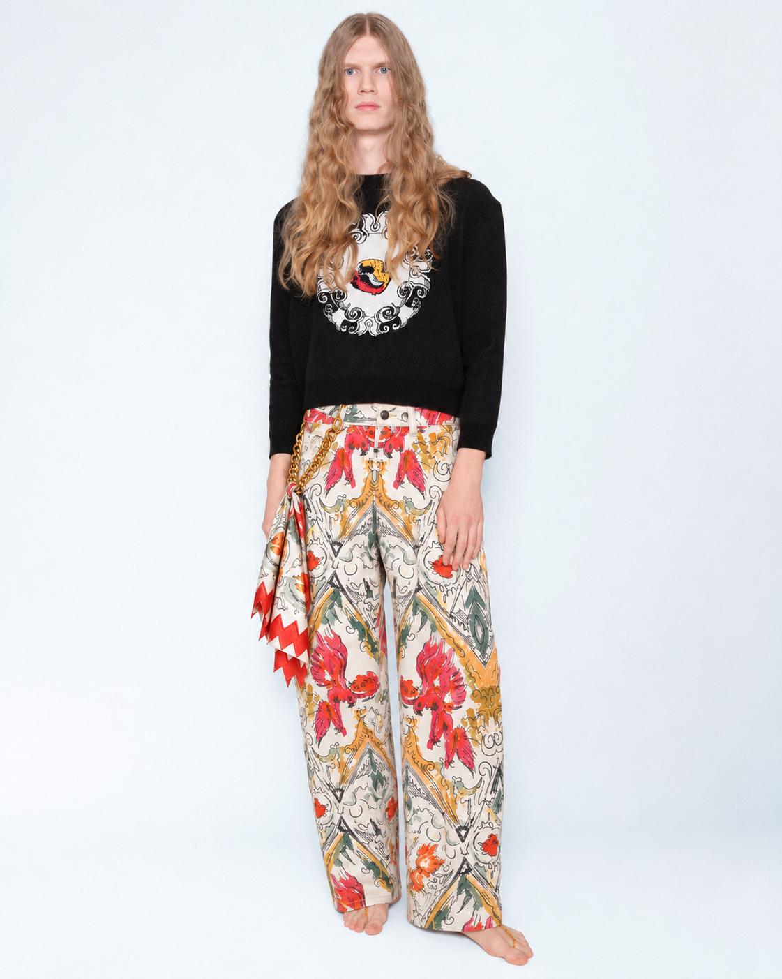 The Phoenix Stretch Jeans worn with a black knit jumper and a silk scarf at the hip, full length
