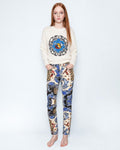 The Silk Wave Stretch Jeans worn with a cream knit jumper, full length