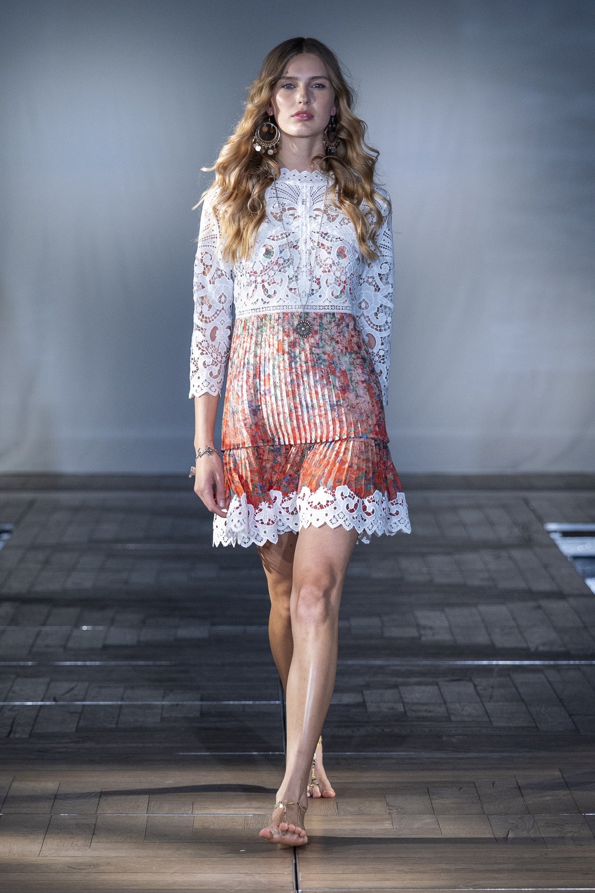 The Pleated Lace Mini Dress worn on the runway