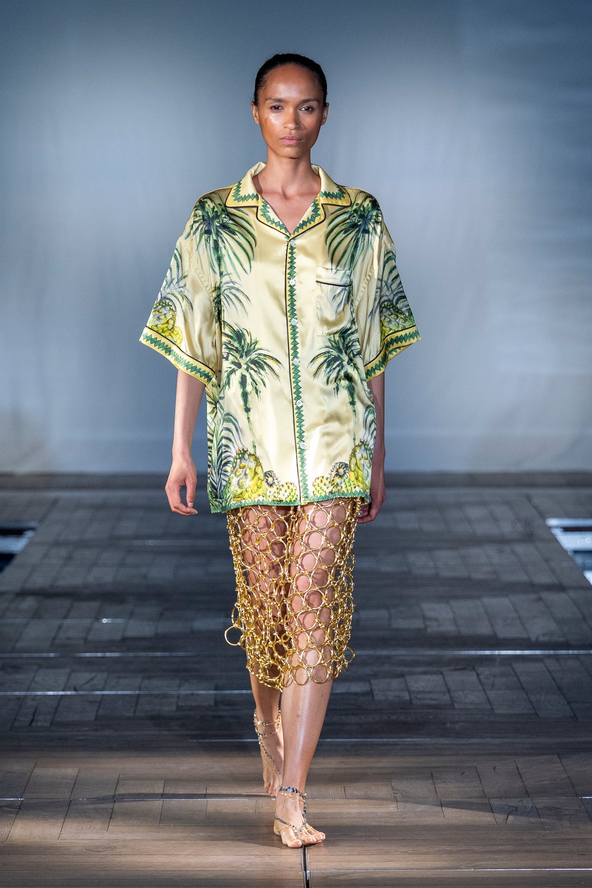Yellow Palm Print Shirt worn on the runway with a gold chain skirt
